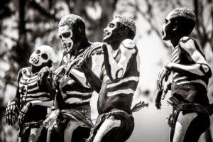 A group of people with painted faces and body paint.