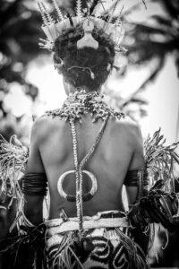 A woman with a necklace and bracelets on her back.