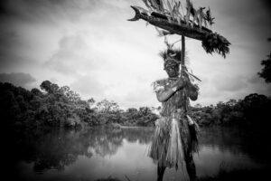 A man in traditional dress holding an umbrella.