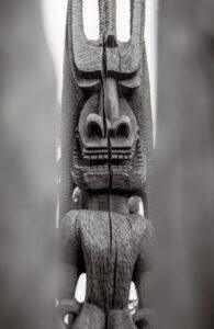 A wooden statue of an animal in the middle of a building.