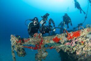 A group of scuba divers on the ocean floor.