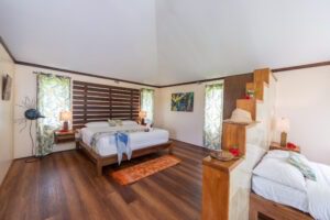 A bedroom with wood floors and white walls.